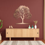 Copper Tree of Life metal wall art displayed on a warm red accent wall above a modern wooden cabinet