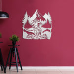 White mountain bike metal wall art with pine trees and mountains displayed on a red wall